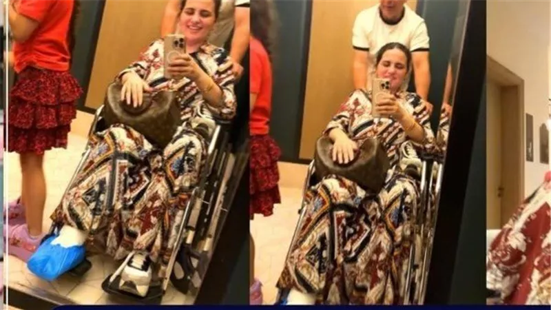 ظهور زوجة حسام حسن على كرسي متحرك بعد إصابة في القدم والعميد يرافقها بنفسه 